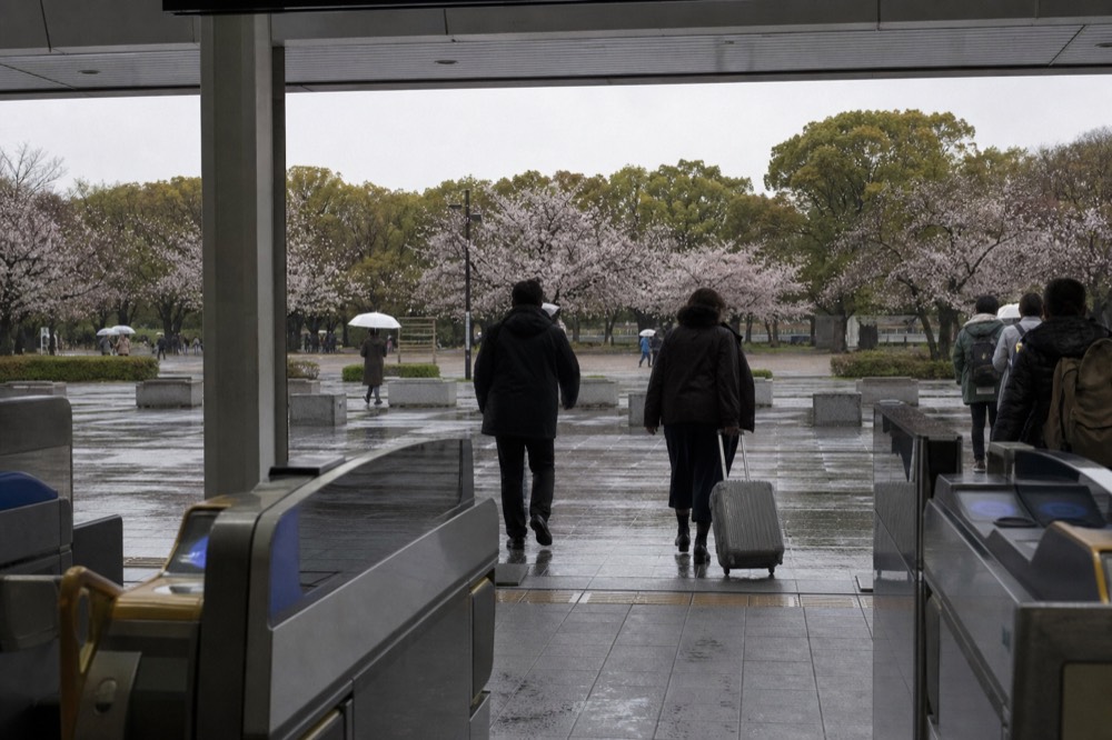 Commuters and travellers walking from Morinomiya station toward the castle park entrance