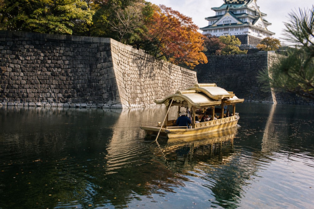 A replica boat floating on the inner moat beside the castle stone walls