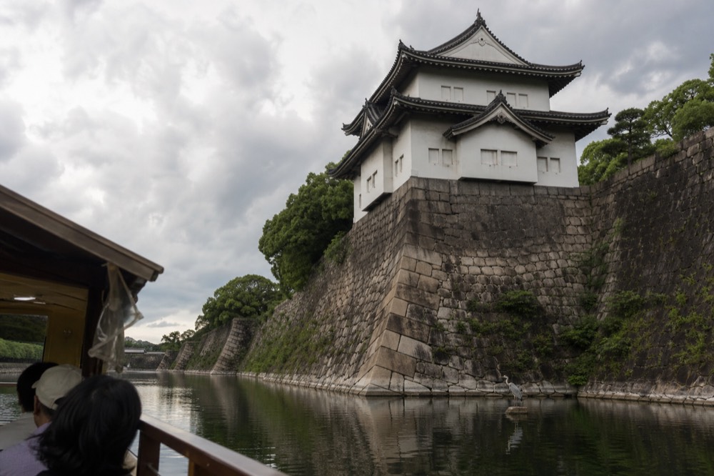 The Tokugawa-era turrets and stone walls of Osaka Castle seen from the inner moat