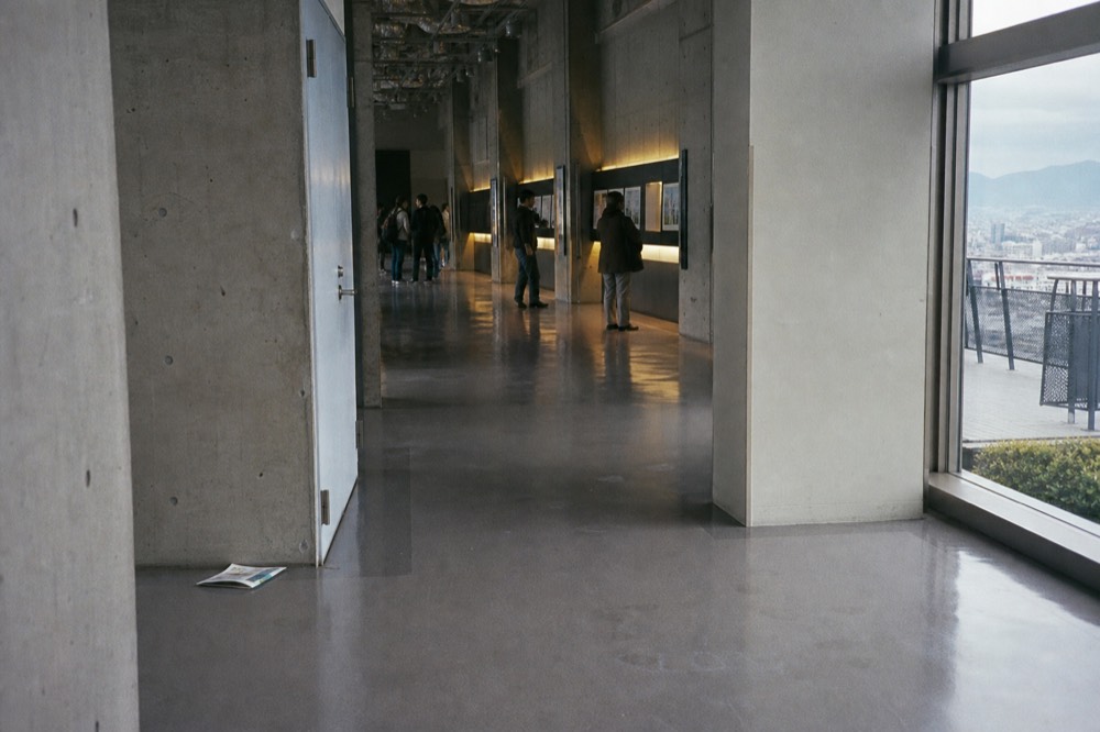 Visitors reading display panels along a museum corridor inside the castle tower